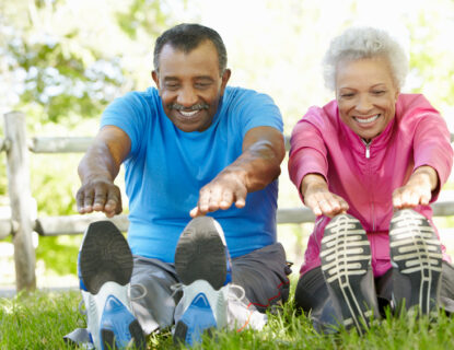 Senior African American Couple Exercising In Park